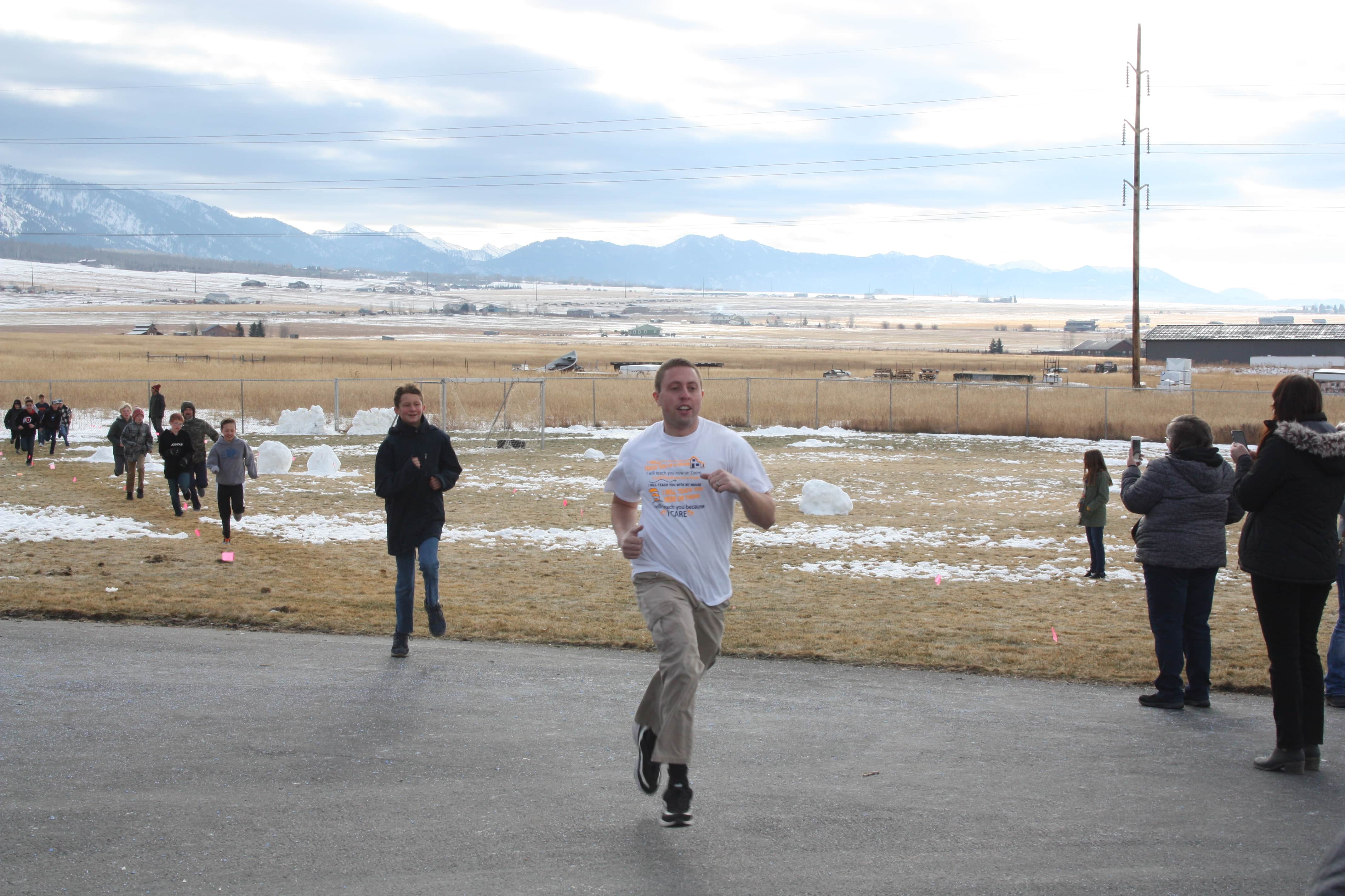 Student and staff running to the finish line